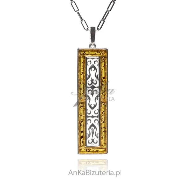Srebrna zawieszka z żółtym bursztynem i ażurowym pionowym ornamencie
