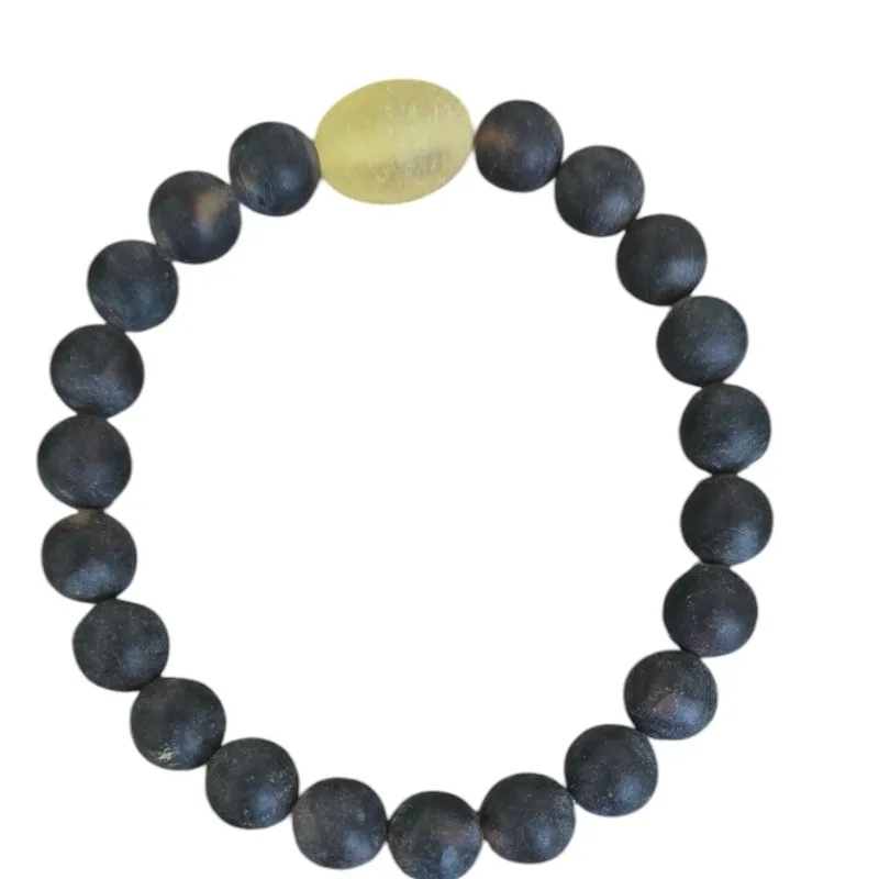 Bransoletka z matowych bursztynowych kulek i owalną żółtą średnica 0,8 cm