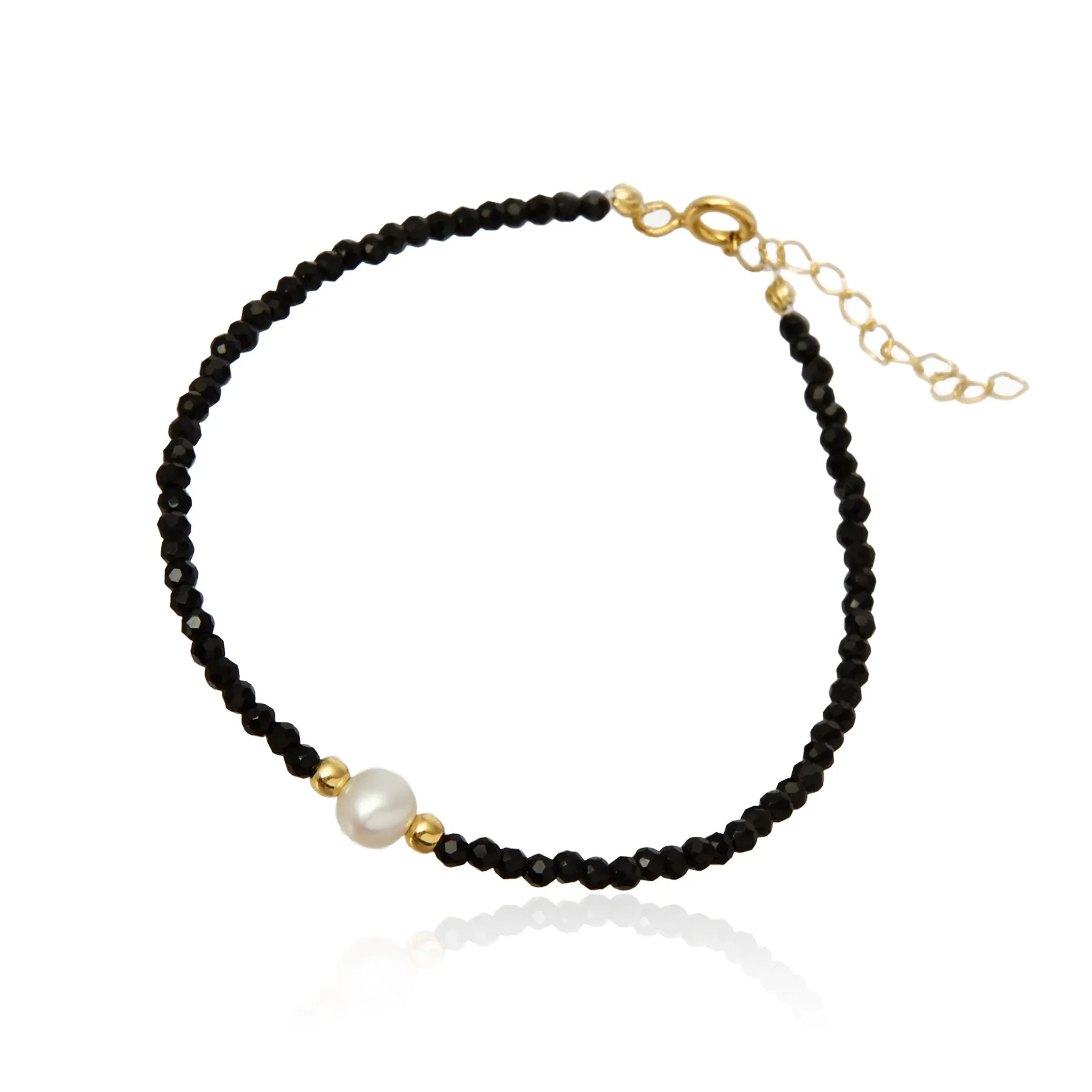 Bransoletka srebrna pozłacana z białą perełką i czarnymi spinelami
